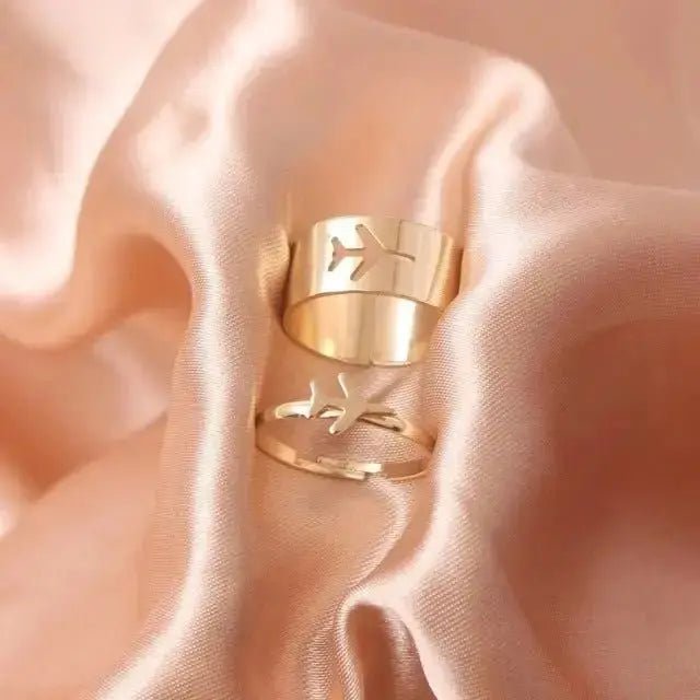 Elegant gold butterfly rings for women displayed on soft satin fabric