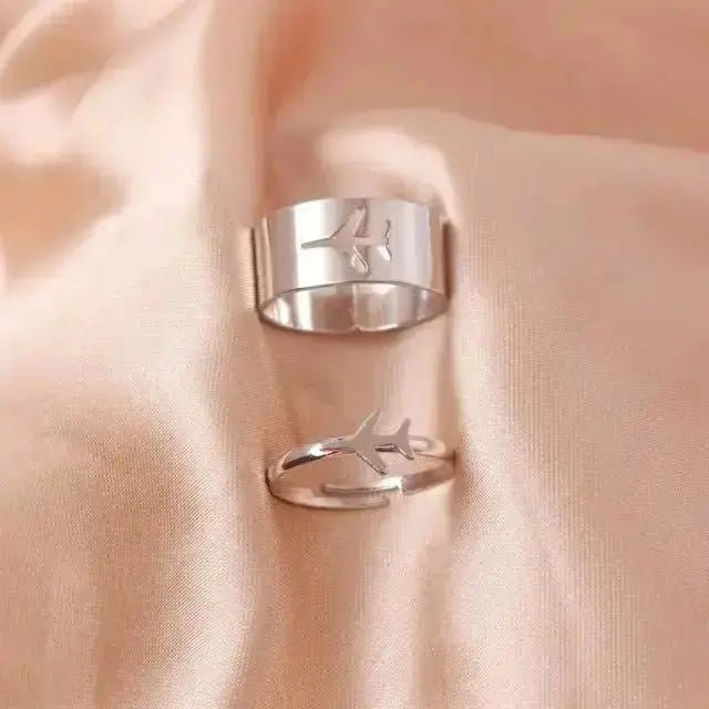 Two elegant silver butterfly rings for women with a minimalist design on soft fabric