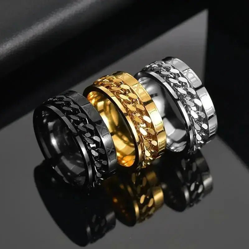 Three stylish roman numeral spinner rings in black, gold, and silver with intricate designs